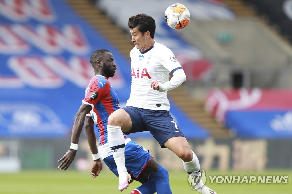 In this Associated Press file photo from July 26, 2020, Son Heung-min of Tottenham Hotspur (R) battles Cheikhou Kouyate of Crystal Palace for the ball during their Premier League match at Selhurst Park Stadium in London. (Yonhap)