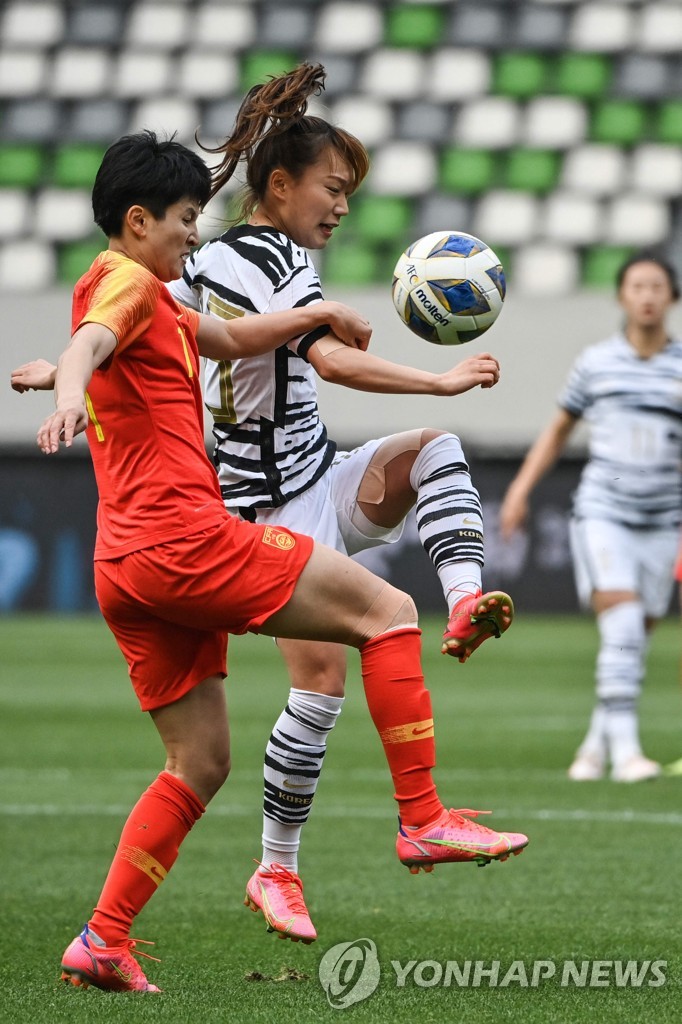 In this AFP photo, Jang Sel-gi of South Korea (R) and Wang Shanshan of China battle for the ball during the teams' Olympic women's football qualifying match at Suzhou Olympic Sports Centre in Suzhou, China, on April 13, 2021. (Yonhap)