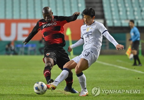 FC Pohang Steelers' Lee Seung-mo, left, celebrates after scoring