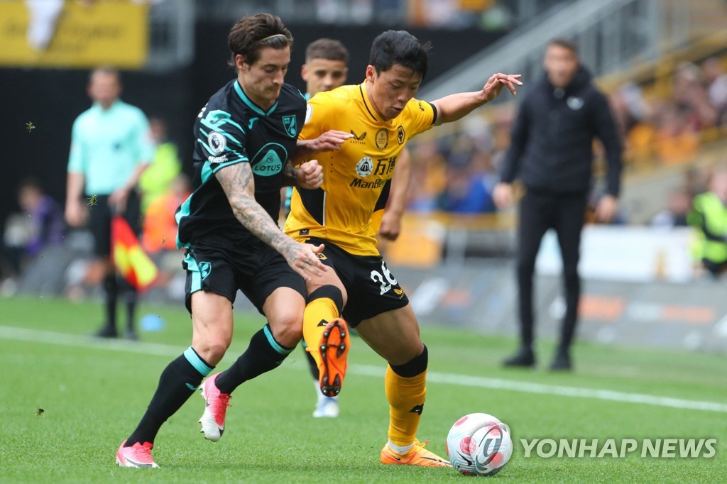 In this AFP file photo from May 15, 2022, Hwang Hee-chan of Wolverhampton Wanderers (R) battles Mathias Normann of Norwich City for the ball during the clubs' Premier League match at Molineux Stadium in Wolverhampton, England. (Yonhap)