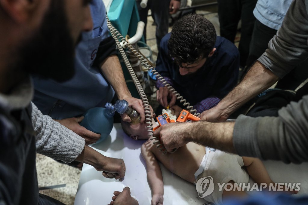시리아 동구타의 공습 현장에서 구조한 아기에게 소생술을 하는 의료진