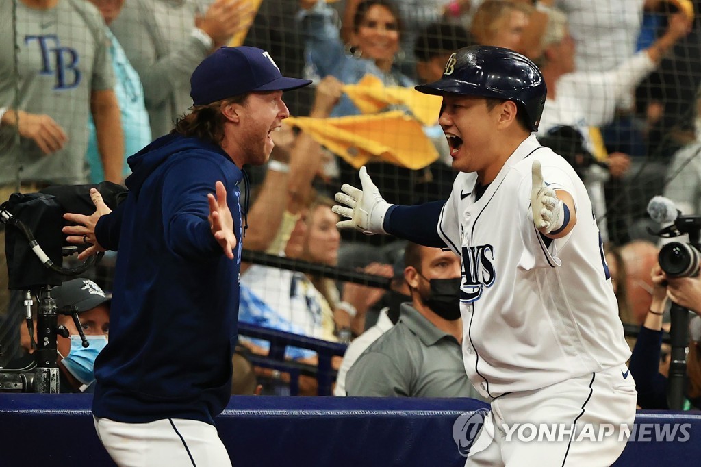 In this Getty Images photo, Choi Ji-man of the Tampa Bay Rays (R) celebrates his solo home run against the Boston Red Sox with teammate Brett Phillips in the bottom of the sixth inning of Game 2 of the American League Division Series at Tropicana Field in St. Petersburg, Florida, on Oct. 8, 2021. (Yonhap)