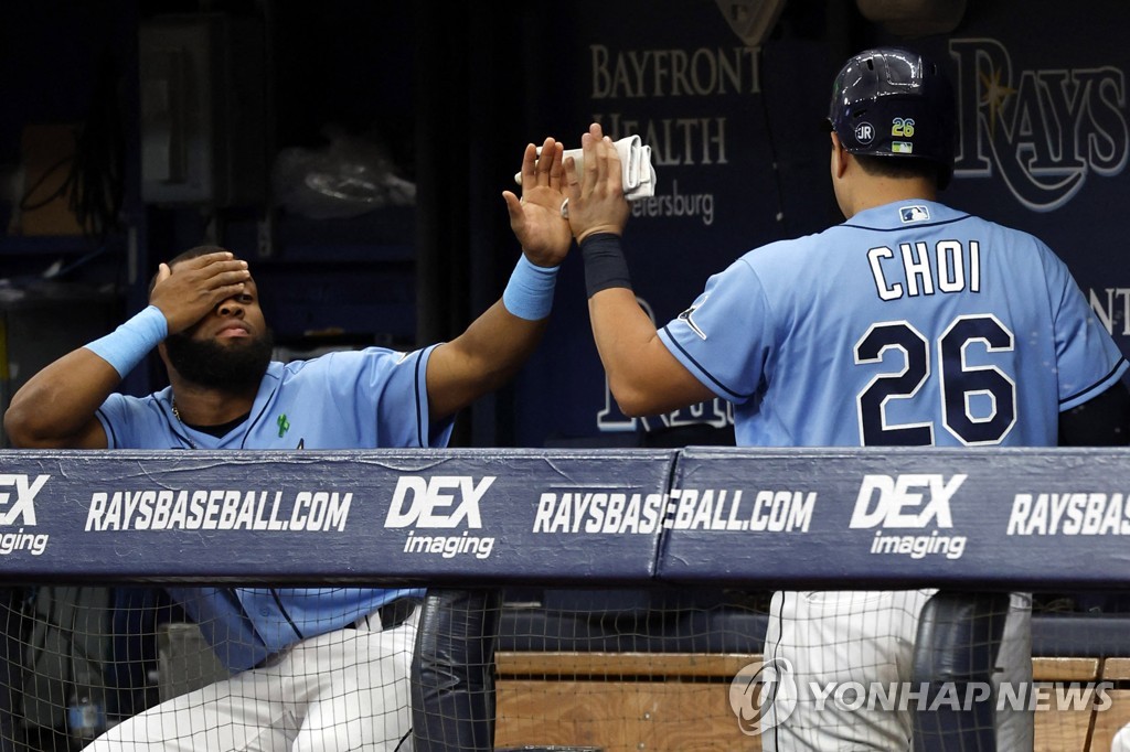 In this USA Today Sports photo via Reuters, Choi Ji-man of the Tampa Bay Rays (R) is congratulated by a teammate after hitting a solo home run against the New York Yankees during the bottom of the second inning of a Major League Baseball regular season game at Tropicana Field in St. Petersburg, Florida, on May 29, 2022. (Yonhap)