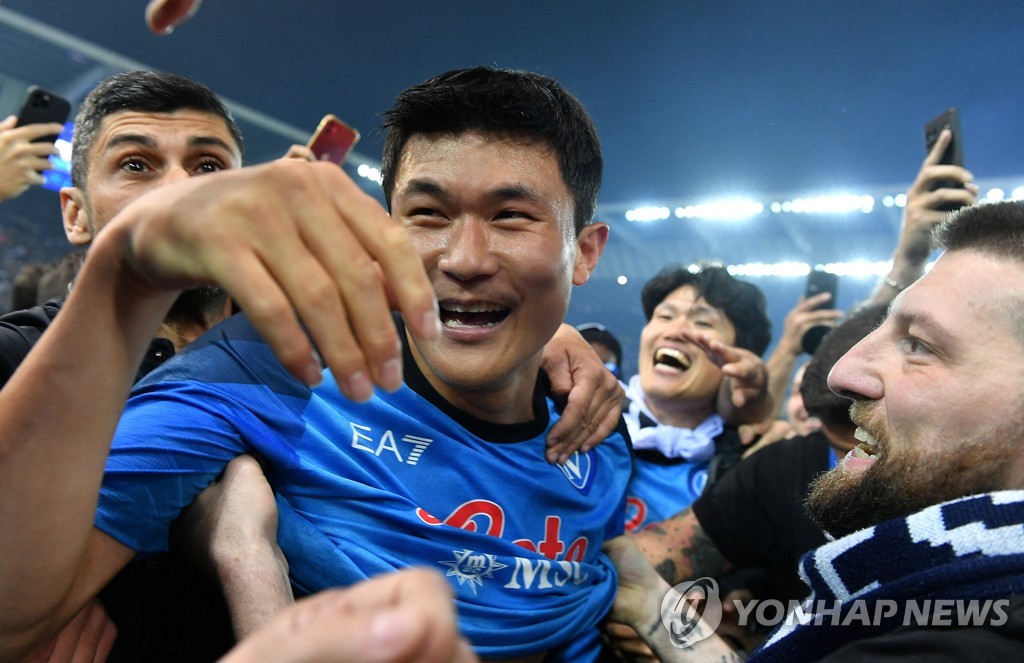 In this Reuters photo, Kim Min-jae of Napoli celebrates with fans after the club clinched the Serie A title following a 1-1 draw against Udinese at Dacia Arena in Udine, Italy, on May 4, 2023. (Yonhap)