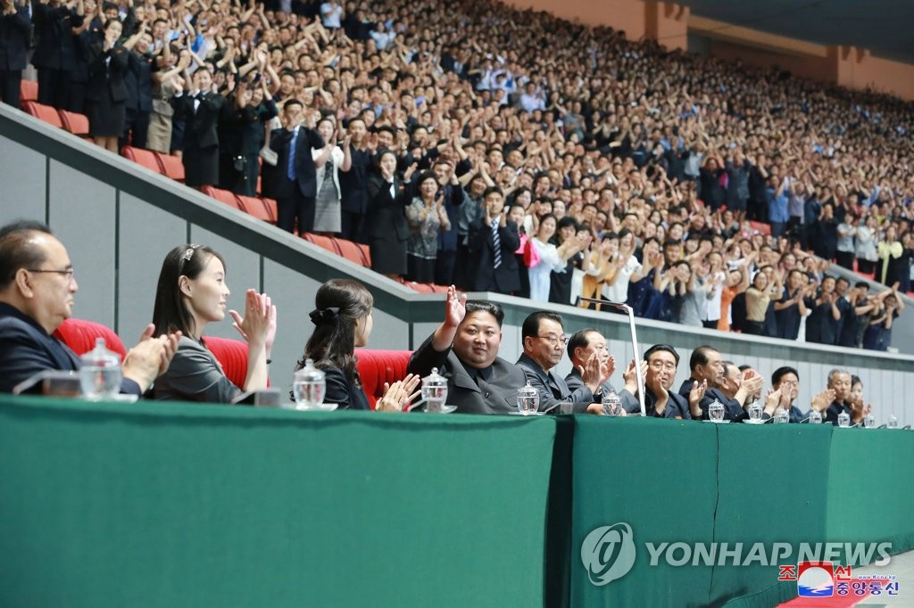 North Korean leader Kim Jong-un (4th from R) waves while watching a propaganda performance called "The Land of People" held June 3, 2019, in this photo released by the North's official Korean Central News Agency on June 4. Kim Yo-jong (2nd from R), the leader's younger sister, also watched the performance. (For Use Only in the Republic of Korea. No Redistribution) (Yonhap)