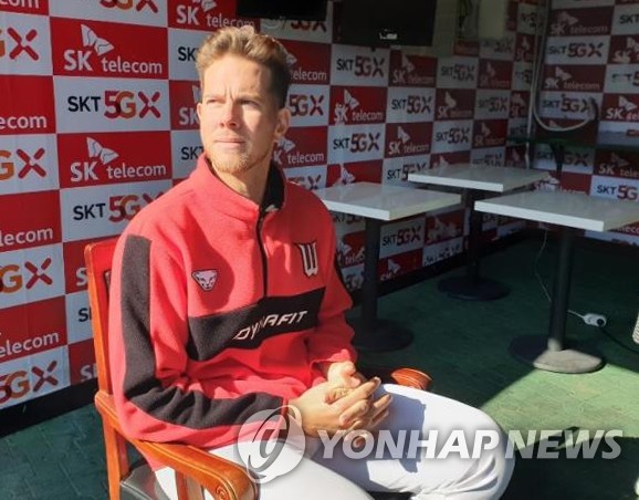 In this file photo from March 16, 2020, Nick Kingham of the SK Wyverns sits in the dugout for an interview following an intrasquad game at SK Happy Dream Park in Incheon, 40 kilometers west of Seoul. (Yonhap)