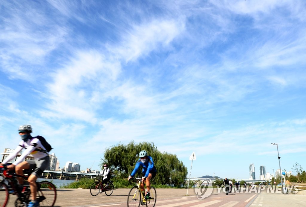 People ride bicycles at Ttukseom Han River Park in eastern Seoul on Oct. 9, 2020. (Yonhap) 