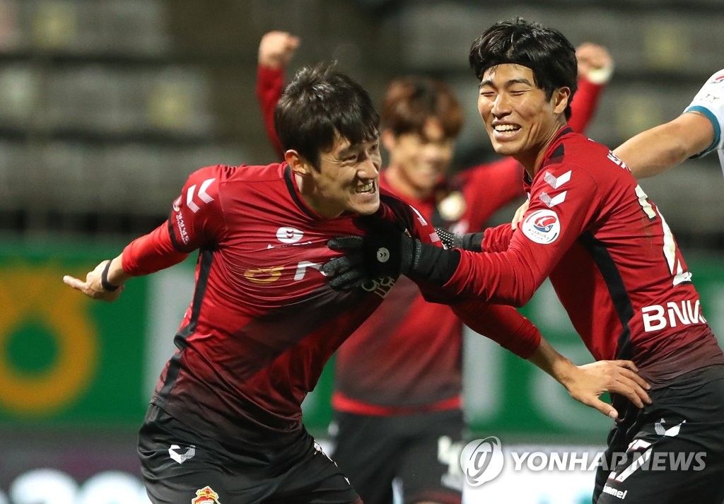 Ko Kyung-min of Gyeongnam FC (L) celebrates his goal against Daejeon Hana Citizen in a K League 2 promotion playoff match at Changwon Football Center in Changwon, 400 kilometers southeast of Seoul, on Nov. 25, 2020. (Yonhap)