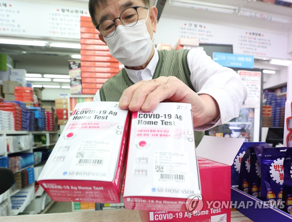 A pharmacist displays COVID-19 home test kits that went on sale in South Korea on April 29, 2021, at a pharmacy in Seoul the same day. (Yonhap)