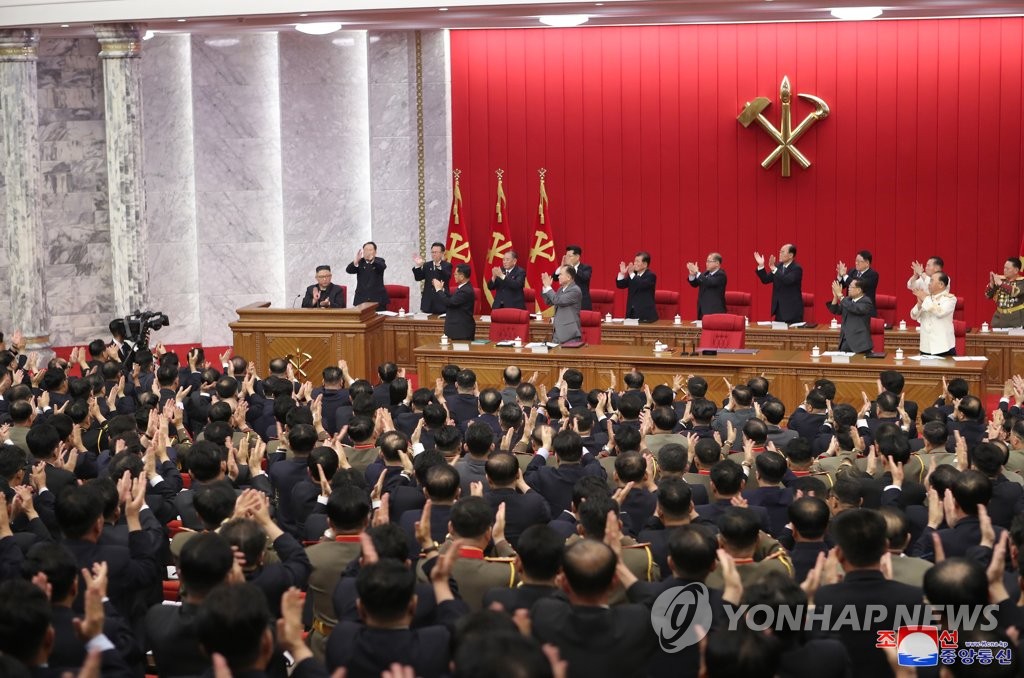Participants applaud North Korean leader Kim Jong-un (L, at the podium) at the third plenary meeting of the eighth Central Committee of North Korea's Workers' Party on its third-day schedule in Pyongyang on June 17, 2021, to discuss international affairs, including the Biden administration's North Korea policy, in this photo provided by the Korean Central News Agency. (For Use Only in the Republic of Korea. No Redistribution) (Yonhap)