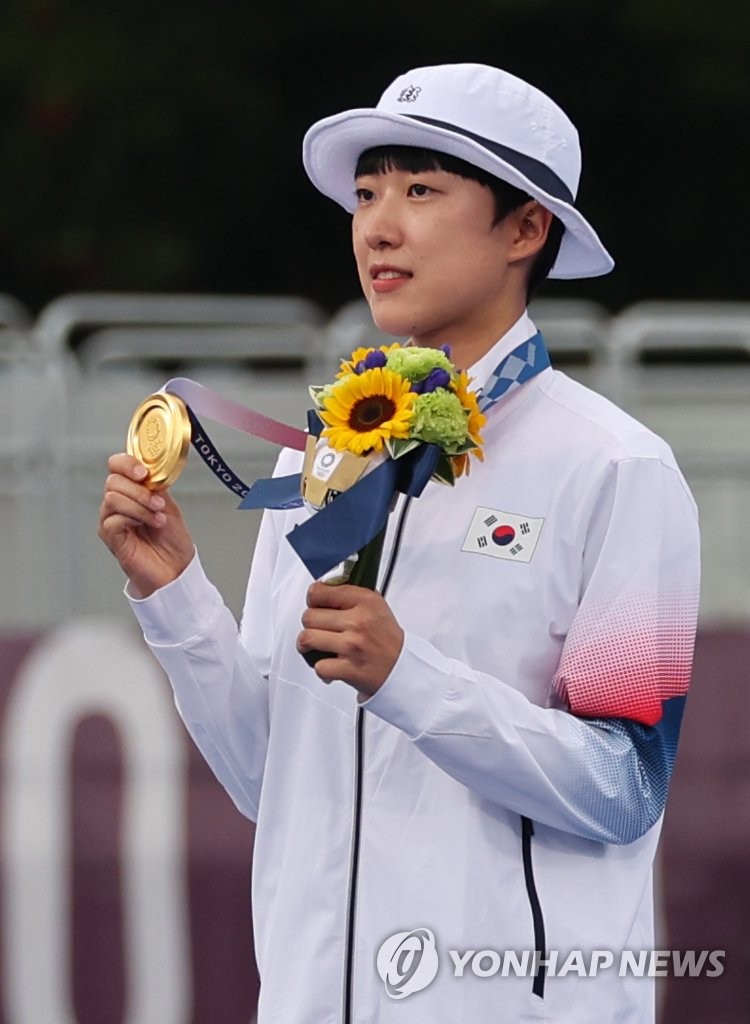 An San of South Korea holds up her gold medal from the women's individual archery event at the Tokyo Olympics at Yumenoshima Park Archery Field in Tokyo on July 30, 2021. (Yonhap)