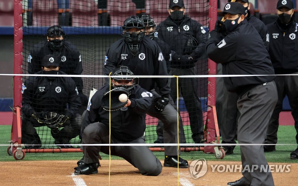 Korea Baesball Organization umpires work on an expanded strike zone with the aid of a pitching machine at Gocheok Sky Dome in Seoul on Jan. 11, 2022. (Yonhap)