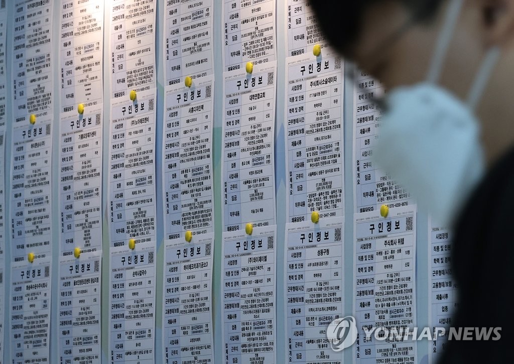 This file photo, taken March 16, 2022, shows a jobseeker looking at employment information at a state-run job arrangement center in Seoul. (Yonhap)
