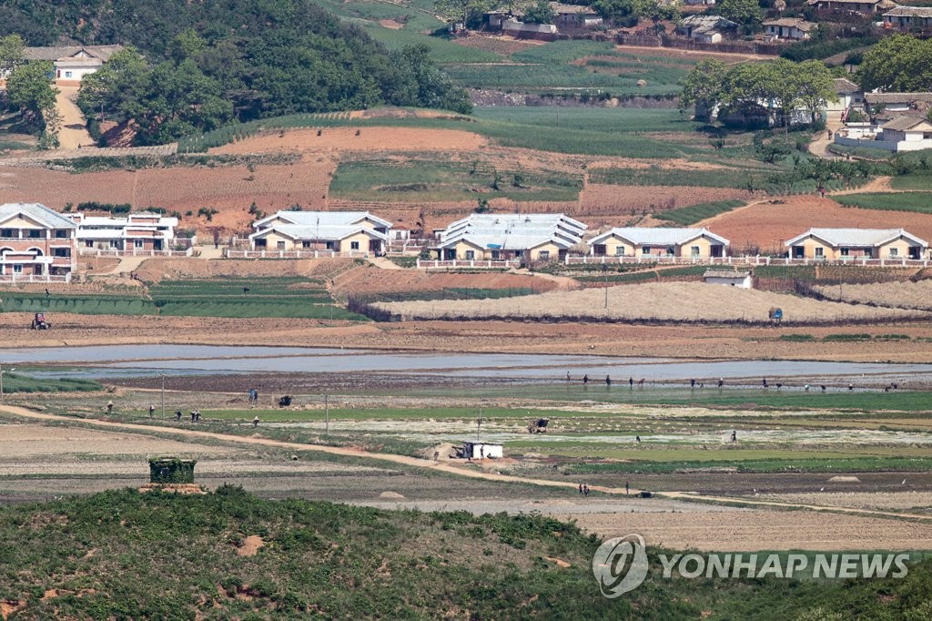 North Koreans farm in North Hwanghae Province, in this file photo, taken May 13, 2022, from the Odusan Unification Tower in the South Korean border city of Paju, 28 kilometers north of Seoul. (Yonhap)