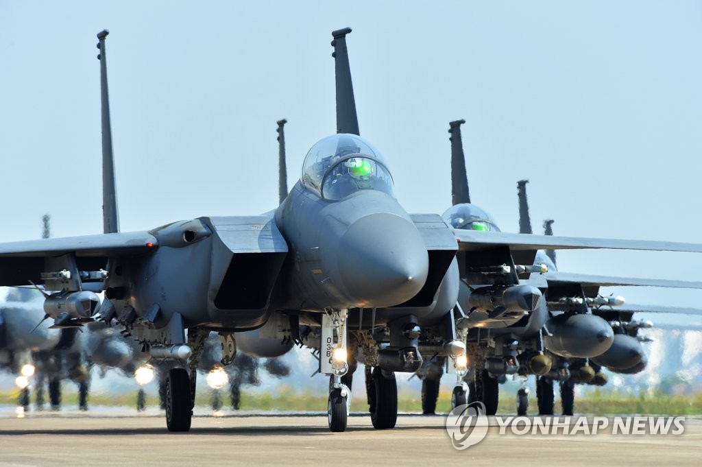 This photo, provided by South Korea's Joint Chiefs of Staff, shows the Air Force's F-15K fighters performing an elephant walk at an unspecified air base on May 24, 2022, to show the country's combat readiness. (PHOTO NOT FOR SALE) (Yonhap)