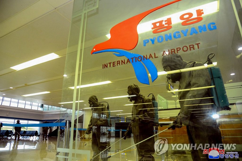 Quarantine officials spray disinfectant at Pyongyang International Airport in the North Korean capital amid the highest alert level on the coronavirus, in this undated file photo released by the North's Korean Central News Agency on June 10, 2022. (For Use Only in the Republic of Korea. No Redistribution) (Yonhap)