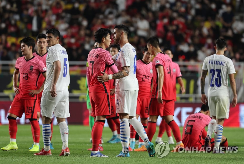 Players for South Korea (in red) and Paraguay walk off the field after a 2-2 draw in their friendly football match at Suwon World Cup Stadium in Suwon, 35 kilometers south of Seoul, on June 10, 2022. (Yonhap)