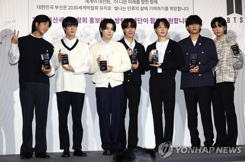 K-pop supergroup BTS poses for the camera after being appointed as the public relations ambassador to host the 2030 World Expo in the southern port city of Busan during a ceremony at Hybe in Seoul on July 19, 2022. (Yonhap)