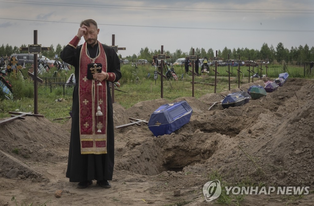 민간인 전쟁 희생자 위해 기도하는 우크라이나 사제