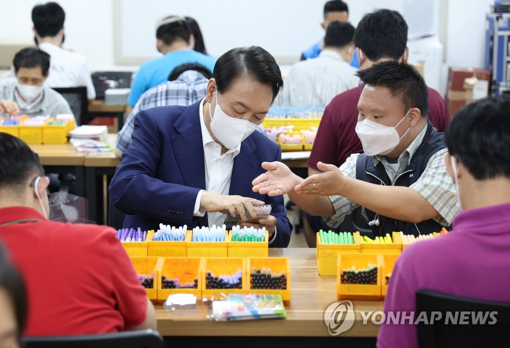 Yoon visits facility for people with developmental disorders