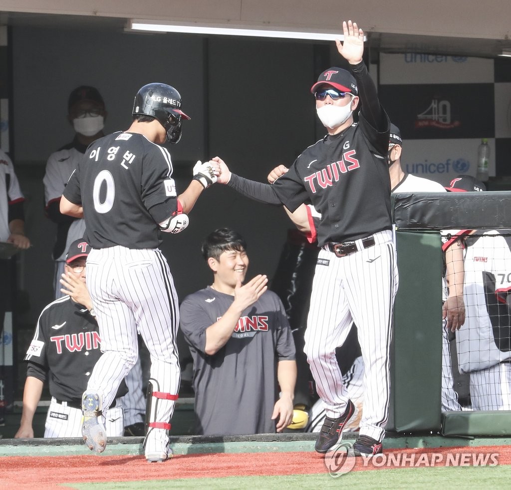 LG Twins manager Ryu Ji-hyun (R) bumps fists with Lee Young-bin following Lee's two-run home run against the Lotte Giants during the top of the seventh inning of a Korea Baseball Organization regular season game at Sajik Stadium in Busan, 325 kilometers southeast of Seoul, on Sept. 4, 2022. (Yonhap)