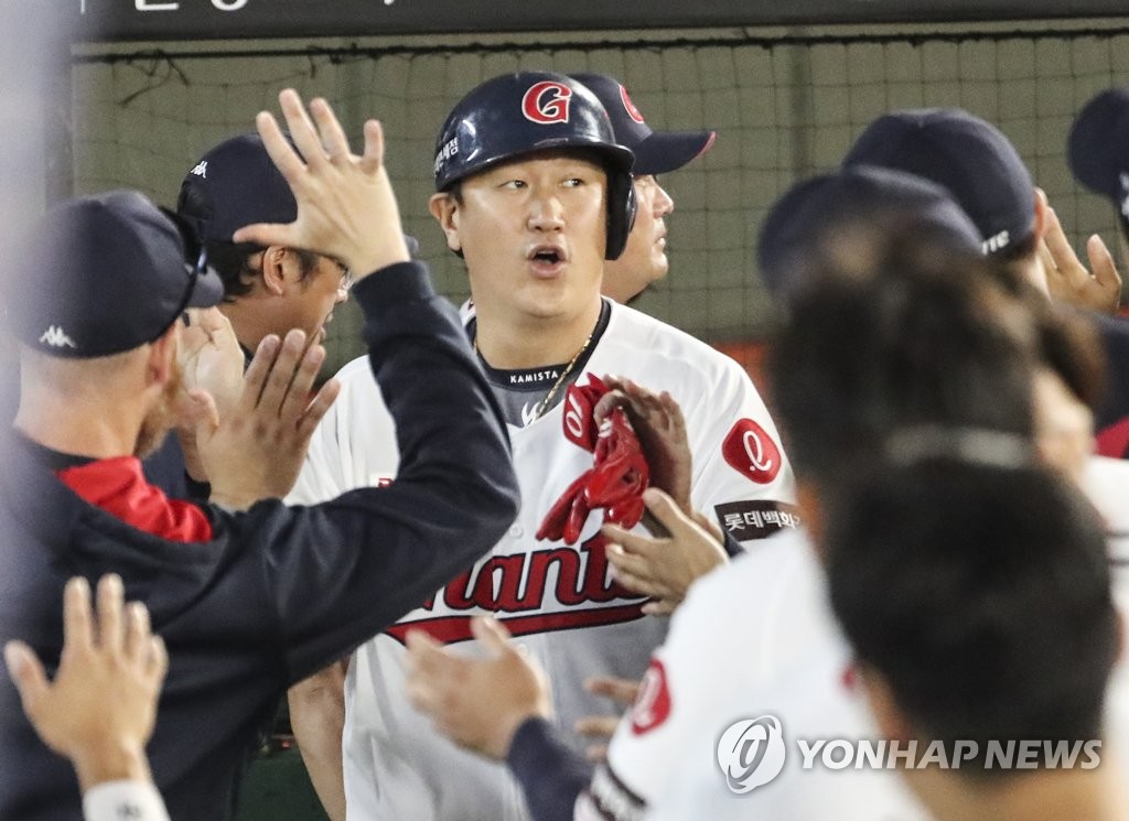 Lee Dae-ho of the Lotte Giants is congratulated by teammates after scoring a run against the Kiwoom Heroes during the bottom of the first inning of a Korea Baseball Organization regular season game at Sajik Baseball Stadium in Busan, 325 kilometers southeast of Seoul, on Sept. 15, 2022. (Yonhap)