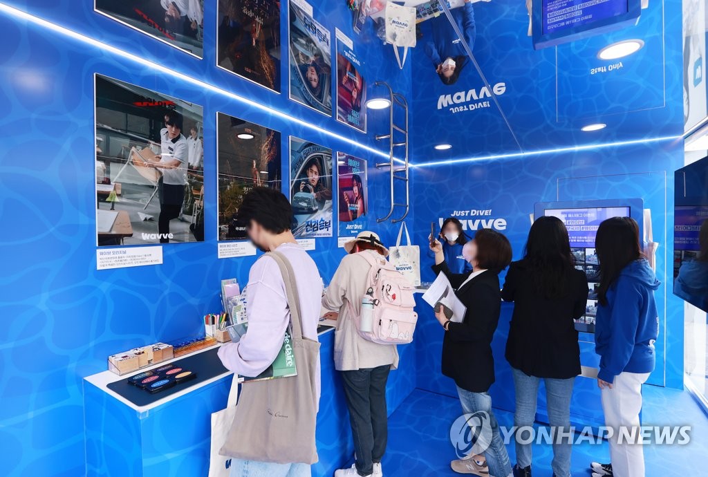 Visitors check out Korean streaming platform Wavve's promotion booth set at the Busan Cinema Center, the venue for the Busan International Film Festival, on Oct. 6, 2022. (Yonhap)