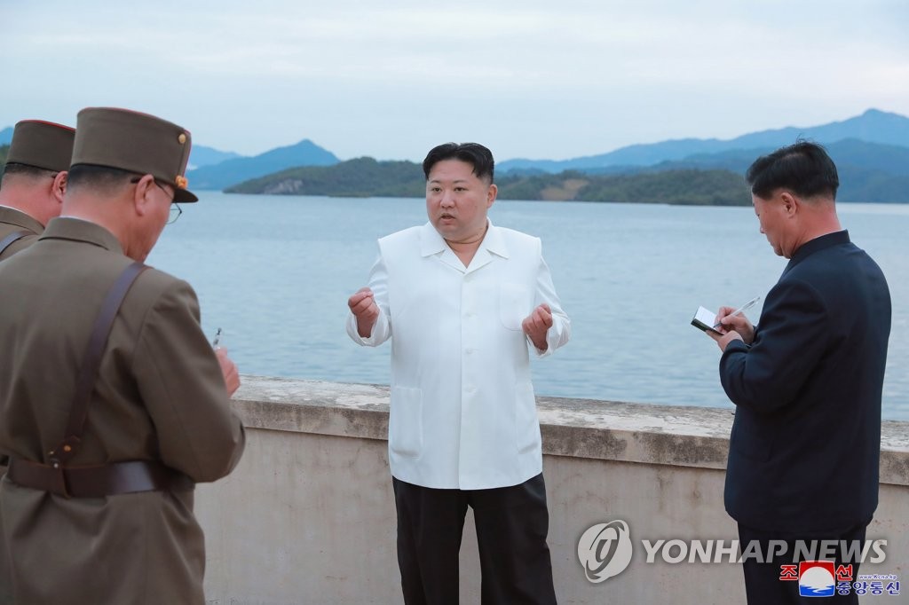 This photo, provided by the Korean Central News Agency on Oct. 10, 2022, shows North Korean leader Kim Jong-un talking to military officials during his inspection of major drills. (For Use Only in the Republic of Korea. No Redistribution) (Yonhap)