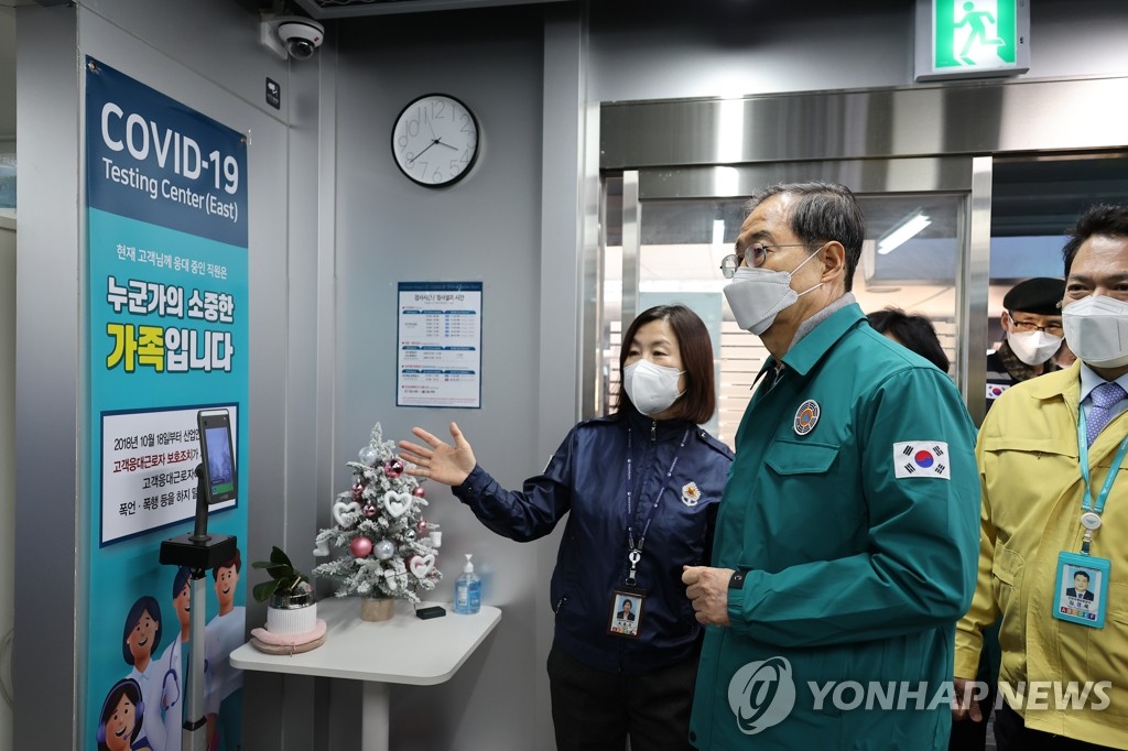 Prime Minister Han Duck-soo (2nd from R) inspects a COVID-19 testing station at Incheon International Airport, west of Seoul, on Jan. 2, 2023, when South Korea began to require PCR tests for all travelers from China as the virus spreads broadly in the neighboring country. (Yonhap)