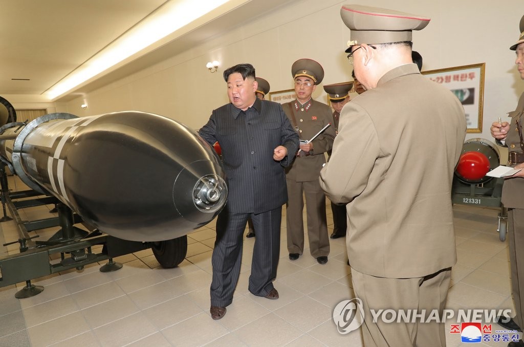 This photo, carried by North Korea's official Korean Central News Agency on March 28, 2023, shows North Korean leader Kim Jong-un (L) guiding the country's nuclear weaponization project the previous day, while calling for expanding the production of weapons-grade nuclear materials. (For Use Only in the Republic of Korea. No Redistribution) (Yonhap)