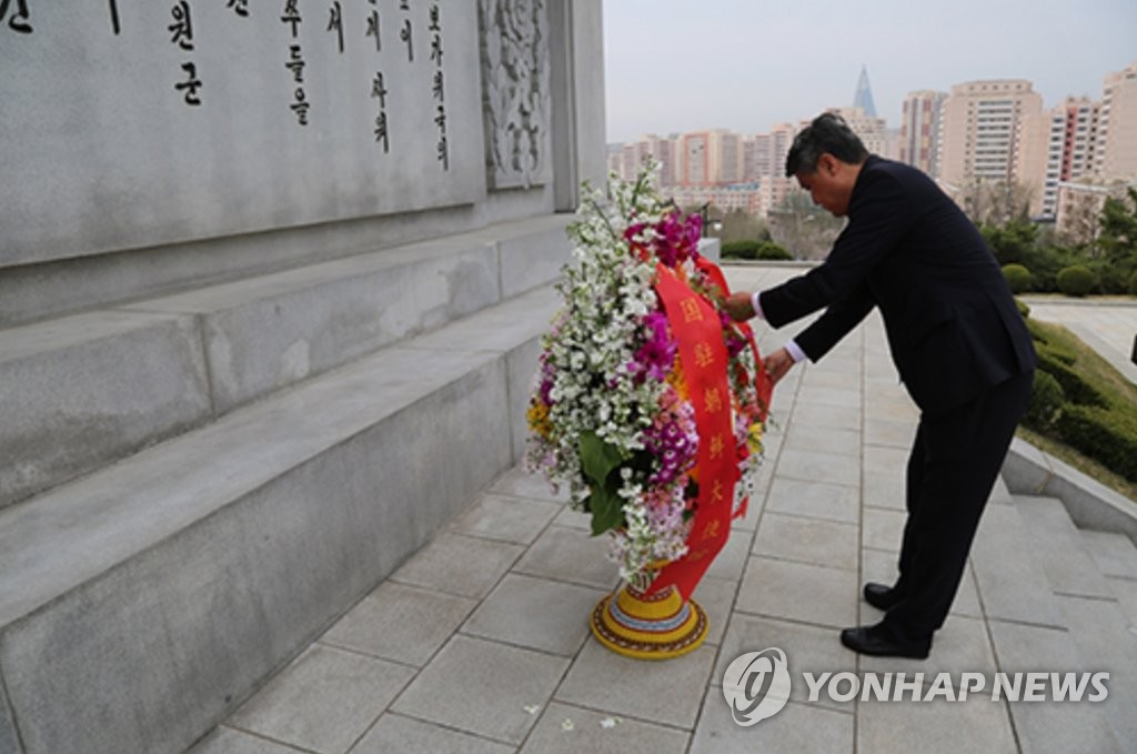 Esta foto de archivo, capturada del sitio web de la Embajada de China en Corea del Norte el 5 de abril de 2023, muestra al nuevo embajador de China en el Norte, Wang Yajun, colocando una canasta de flores frente a la Torre de la Amistad en Pyongyang y rindiendo homenaje a los chinos caídos. soldados que lucharon junto con el Norte durante la Guerra de Corea de 1950-53.  (FOTO NO A LA VENTA) (Yonhap)