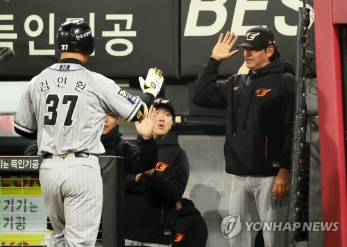 In this file photo from April 11, 2023, Carlos Subero (R), then manager of the Hanwha Eagles, greets his player Kim In-hwan after Kim hit a solo home run against the Kia Tigers during the top of the eighth inning of a Korea Baseball Organization regular season game at Gwangju-Kia Champions Field in Gwangju, some 270 kilometers south of Seoul. (Yonhap)