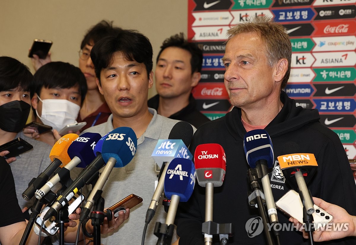 Jurgen Klinsmann (R), head coach of the South Korean men's football team, speaks to reporters at Incheon International Airport, west of Seoul, on Sept. 14, 2023. (Yonhap)