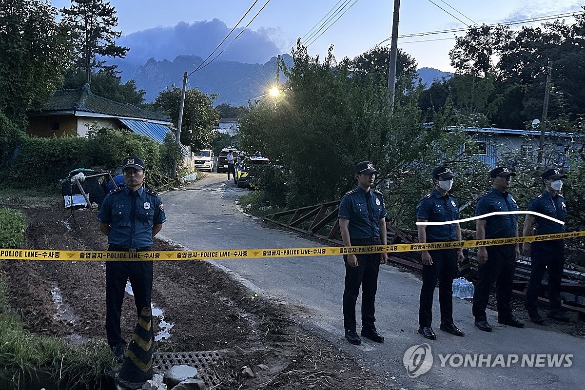 Police stand guard in front of a house in Yeongam, South Jeolla Province, where a family of five were found dead on Sept. 15, 2023. (Yonhap)