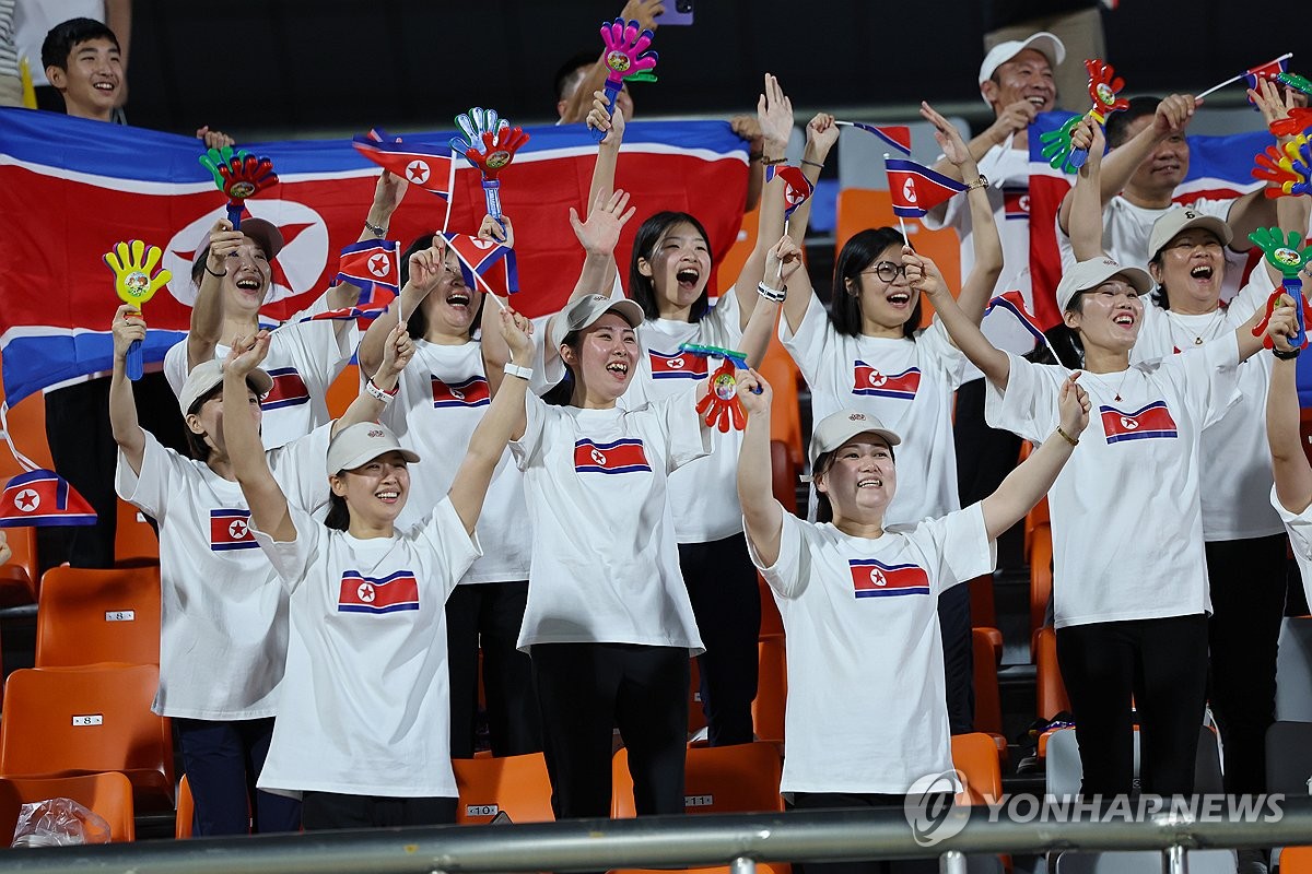 North Korean cheerleaders celebrate their team's 1-0 win over Kyrgyzstan in their Group F match of the men's football tournament at the Asian Games at Zhejiang Normal University East Stadium in Jinhua, China, on Sept. 21, 2023. (Yonhap)