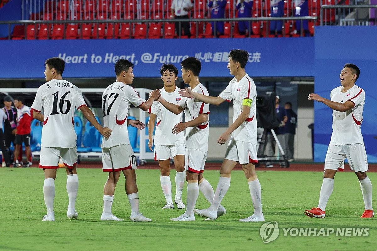 North Korean players celebrate their 1-0 win over Kyrgyzstan in their Group F match of the men's football tournament at the Asian Games at Zhejiang Normal University East Stadium in Jinhua, China, on Sept. 21, 2023. (Yonhap)