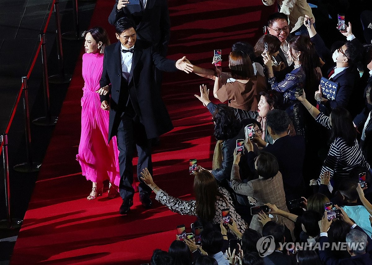 Hong Kong star Chow Yun-fat (2nd from L), the recipient of the Asian Filmmaker of the Year award, walks the red carpet during the opening ceremony of the Busan International Film Festival held at the Busan Cinema Center in the southeastern port city on Oct. 4, 2023. (Yonhap)