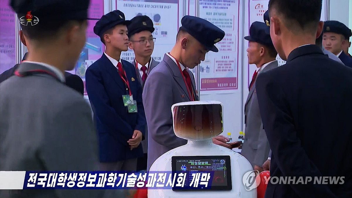 This image, captured from footage of North Korea's Korean Central Television on Oct. 26, 2023, shows North Korean college students looking around artificial intelligence robots at a science and technology exhibition on Oct. 24. (For Use Only in the Republic of Korea. No Redistribution) (Yonhap)