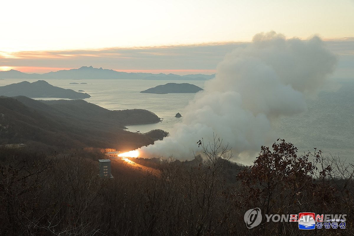 A fire shoots out and smoke rises during a ground jet test of a new type of high-thrust solid engine for intermediate-range ballistic missiles, in this undated photo released by North Korea's official Korean Central News Agency on Nov. 15, 2023. (For Use Only in the Republic of Korea. No Redistribution) (Yonhap)