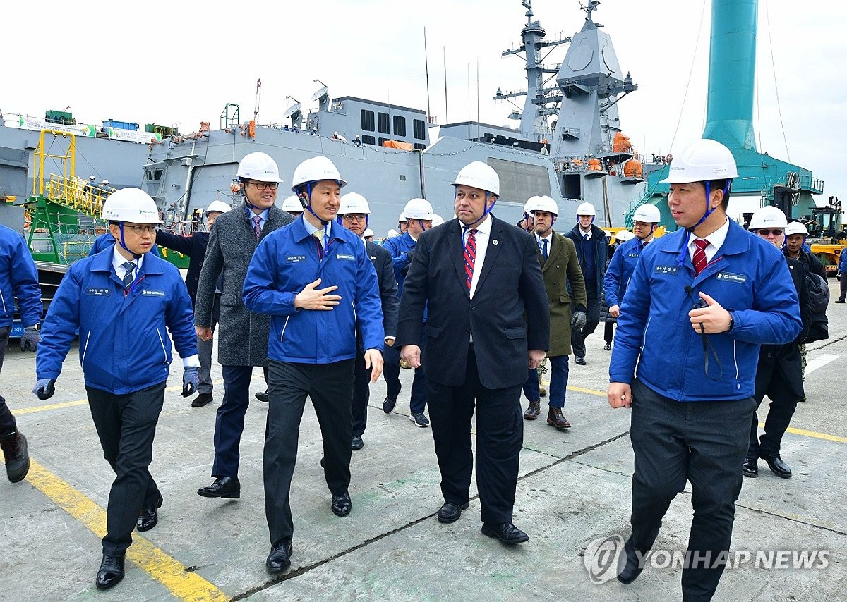 This file photo, provided by HD Hyundai Heavy Industries Co., shows the shipbuilder's Vice Chairman Chung Ki-sun (2nd from L) introducing a naval ship under construction to U.S. Secretary of the Navy Carlos Del Toro (2nd from R) during the latter's visit to the HD Hyundai shipyard in Ulsan, about 300 kilometers southeast of Seoul, on Feb. 27, 2024. (PHOTO NOT FOR SALE) (Yonhap)