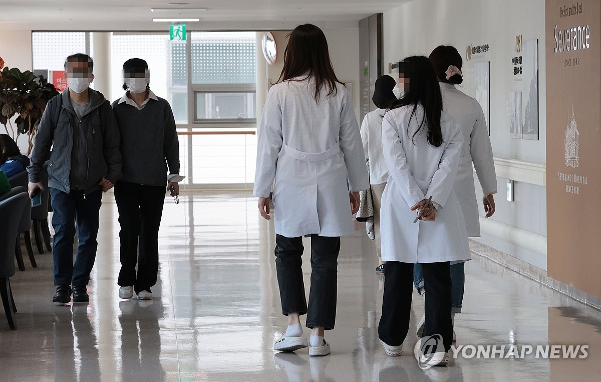 Medical workers walk at a hospital in Seoul on April 2, 2024. (Yonhap)