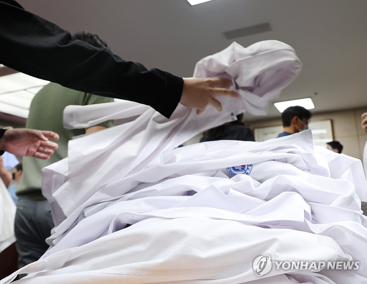 Professors at Wonkwang University Hospital in Iksan, 170 kilometers south of Seoul, leave their lab coats on a pile after submitting their resignations on April 29, 2024. (Yonhap)